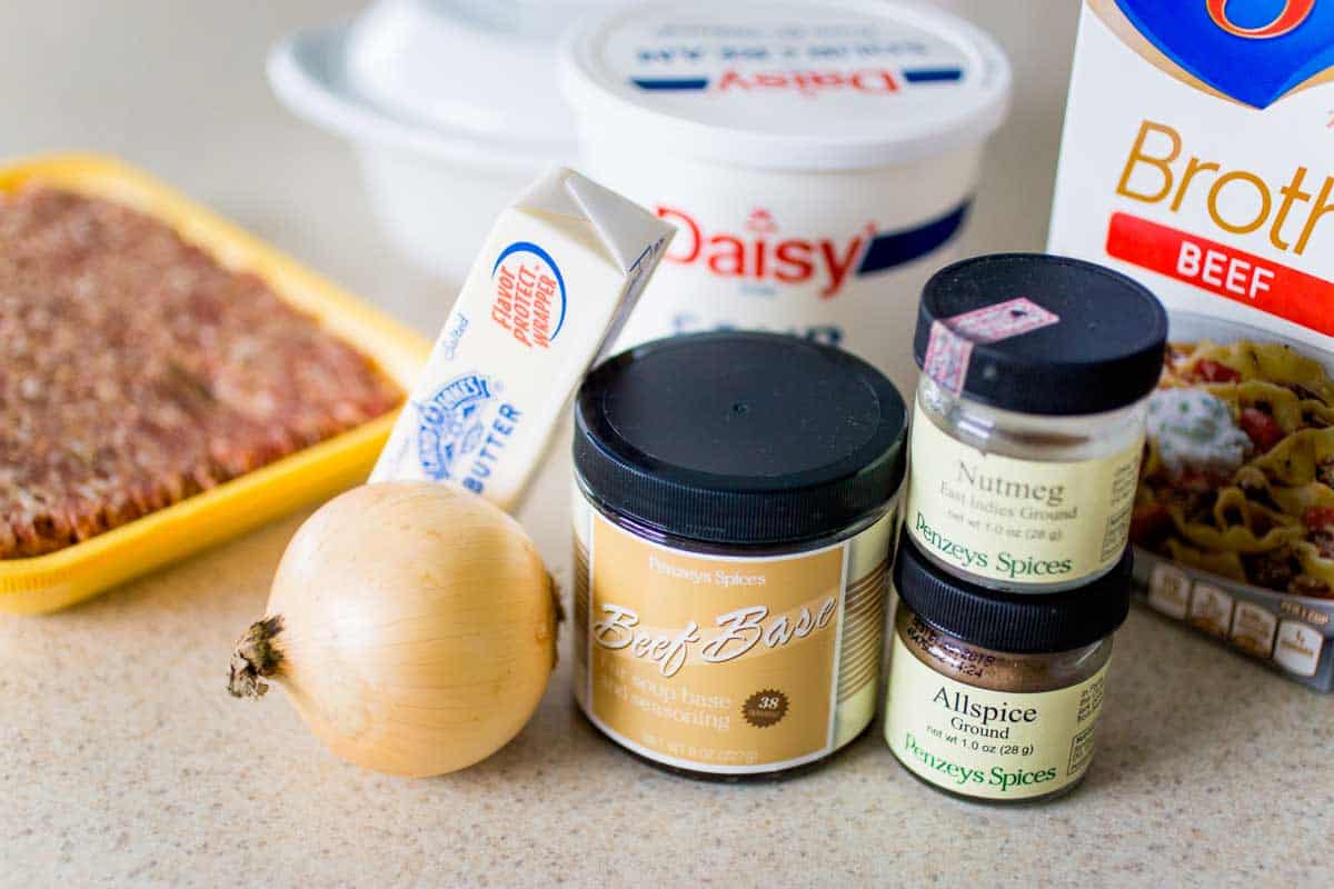 The photo shows all the ingredients to make the sausage dip on the kitchen counter.