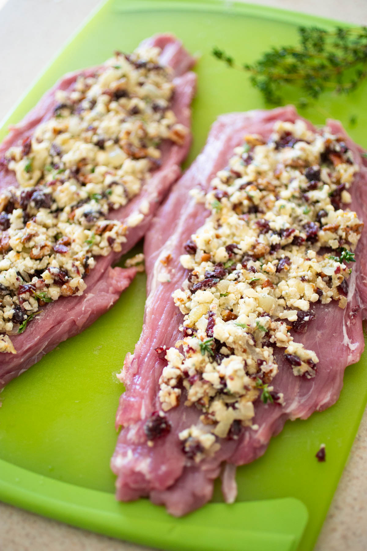 The pork tenderloins have been sliced and rolled flat so they can be stuffed with the filling which sits on top.