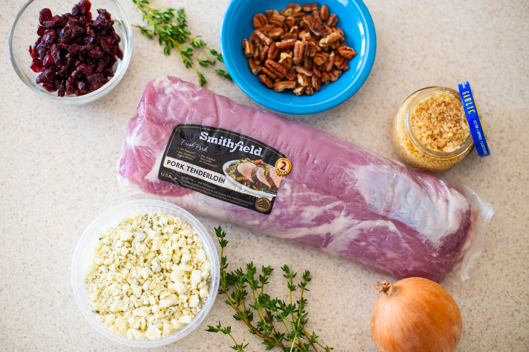 The ingredients to make the blue cheese stuffed pork tenderloin are on the counter.