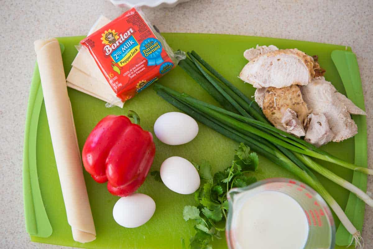 The vegetables, pie crust dough, and turkey meat are on a cutting board.