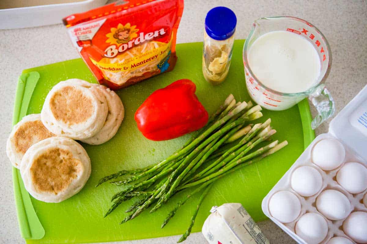 English muffins, eggs, cheese, and the remaining ingredients to make the breakfast casserole are on the counter.