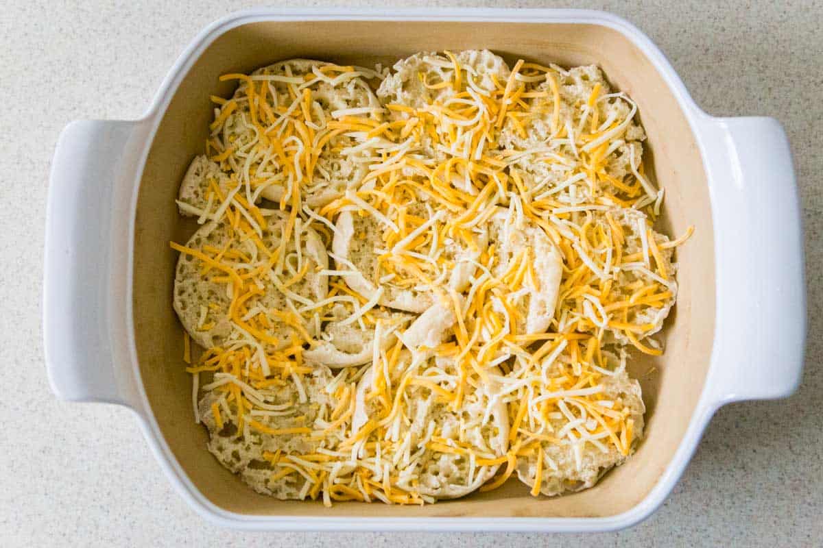 The shredded cheese has been added over the english muffins