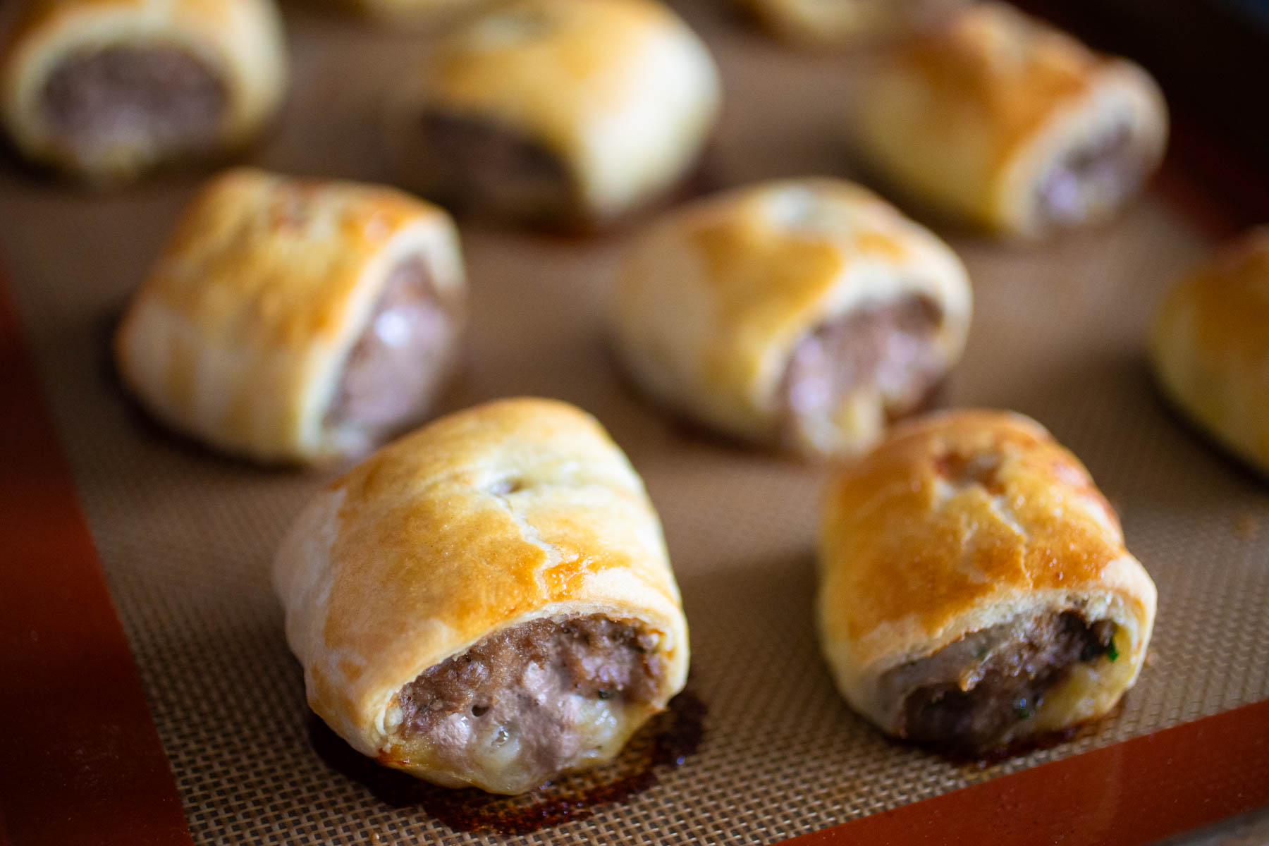 The sausage rolls have a golden brown crust on top.