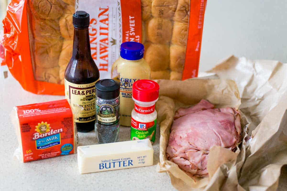 The ingredients to make ham and cheese sliders are on the counter.