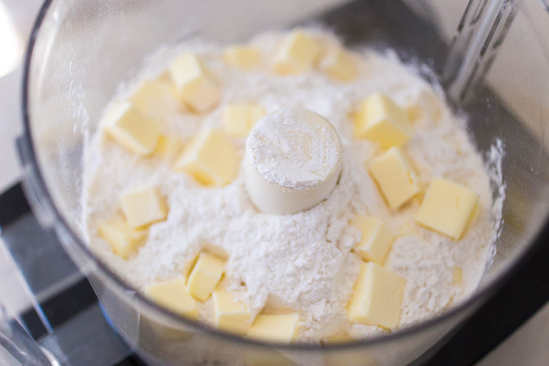 Make the lemon torte crust in the bowl of a food processor.