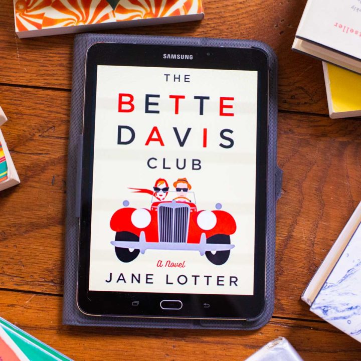 The Bette Davis Club cover appears on a digital reader screen on a table.