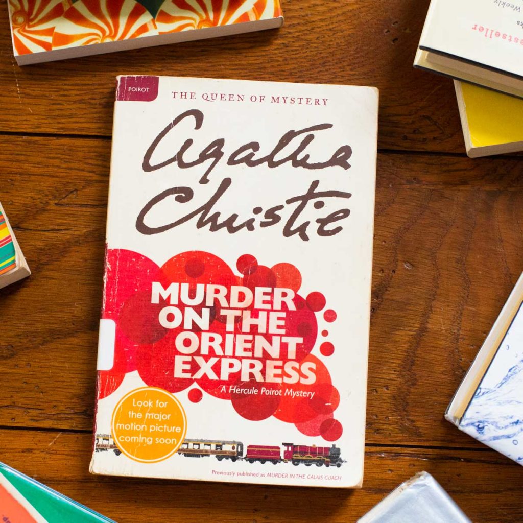A copy of Murder on the Orient Express by Agatha Christie sits on a table.