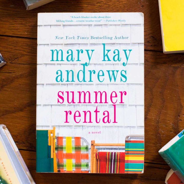 A copy of Summer Rental by Mary Kay Andrews sits on a table.