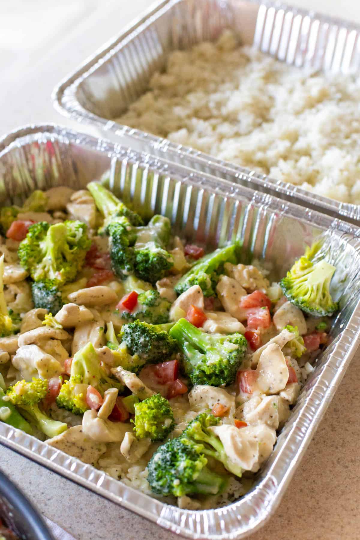 The freezer pan is filled with the chicken casserole, the pan next to it just has rice.