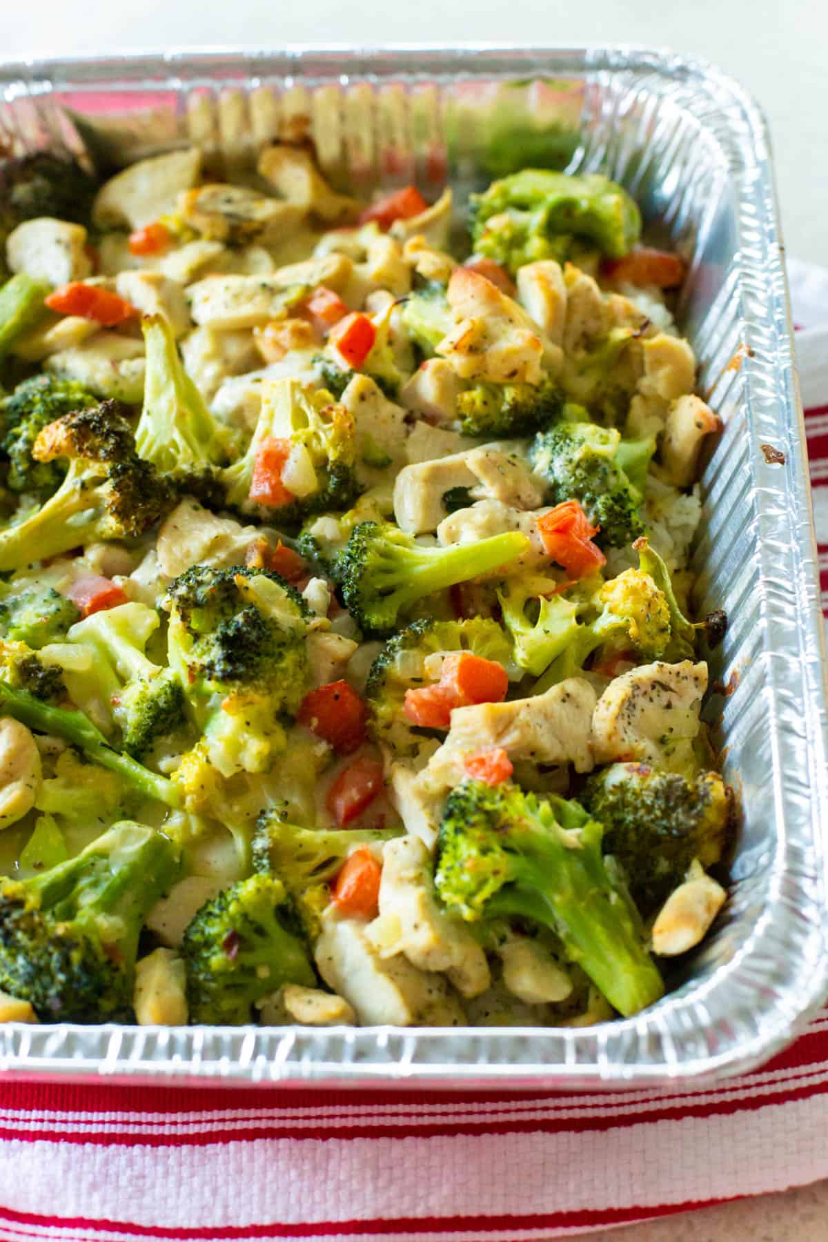 The chicken and broccoli casserole is in the freezer pan but it has been baked and has a golden brown top.