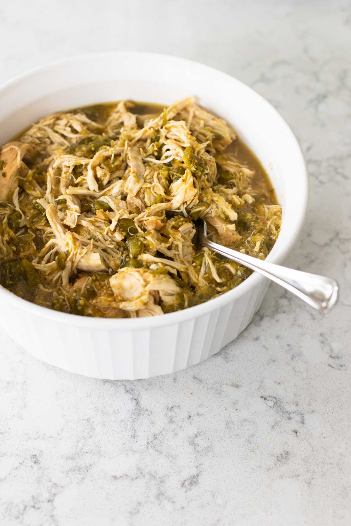 The shredded chicken is in a serving bowl ready for the table.