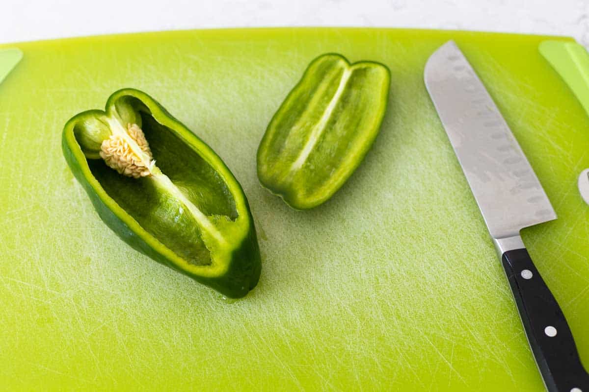 The pepper has been cut in half to show the seeds.