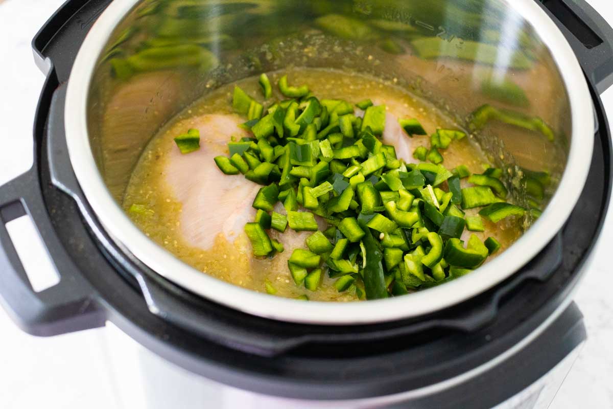 The chopped poblano pieces are added to the Instant Pot.