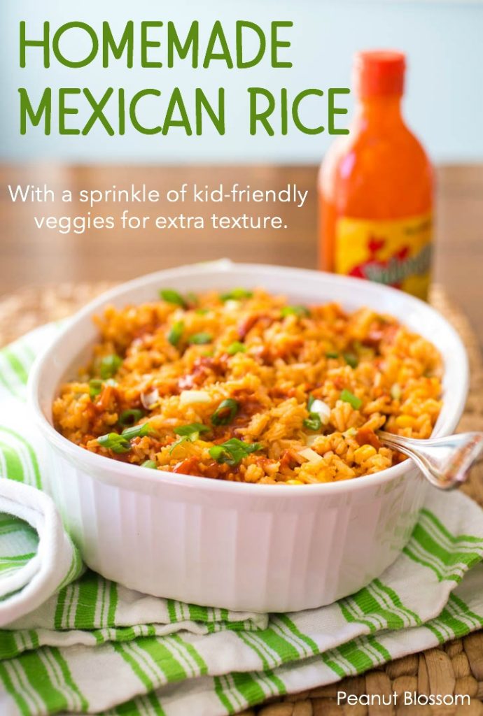 Homemade Mexican Rice in a white baking dish with hot sauce in the background.