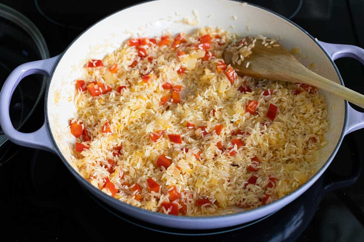 The rice is added to the skillet and stirred into the veggies.