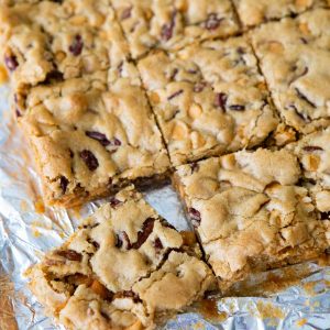 A batch of butterscotch brownies have been cut into squares on a piece of foil.