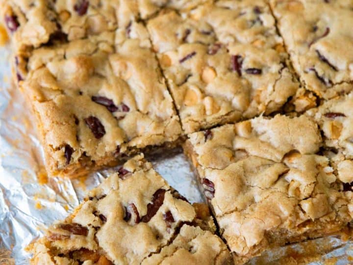 A batch of butterscotch brownies have been cut into squares on a piece of foil.
