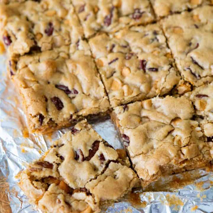 A batch of butterscotch brownies have been cut into squares on a piece of foil.