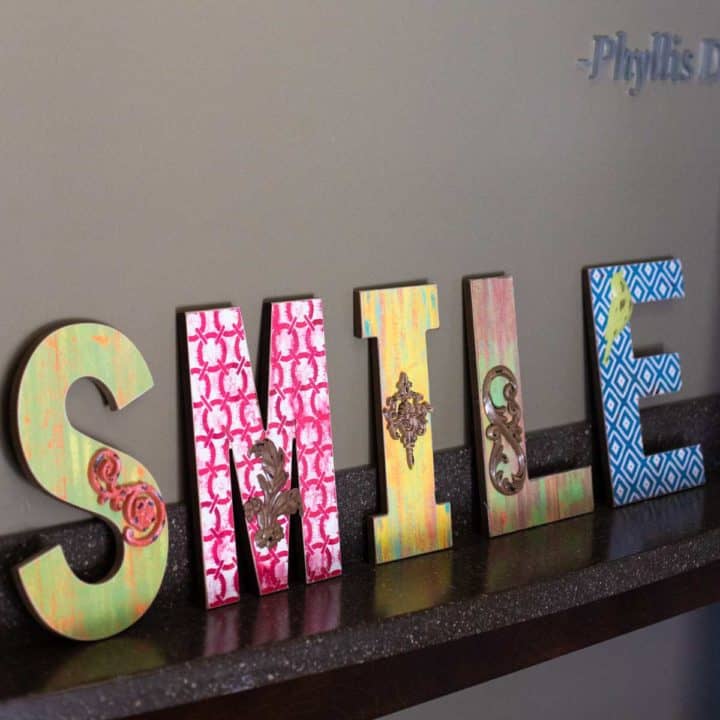 A sign that says "SMILE" in colorful patterns.