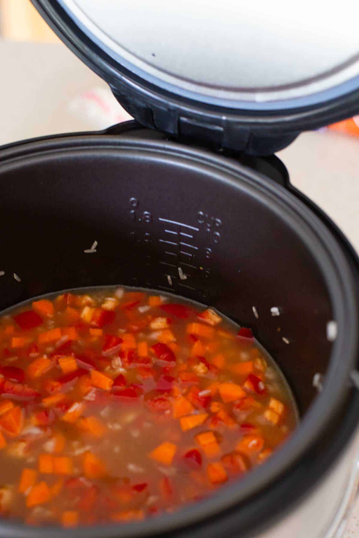 The carrots and red peppers have been added to the rice in the Instant Pot