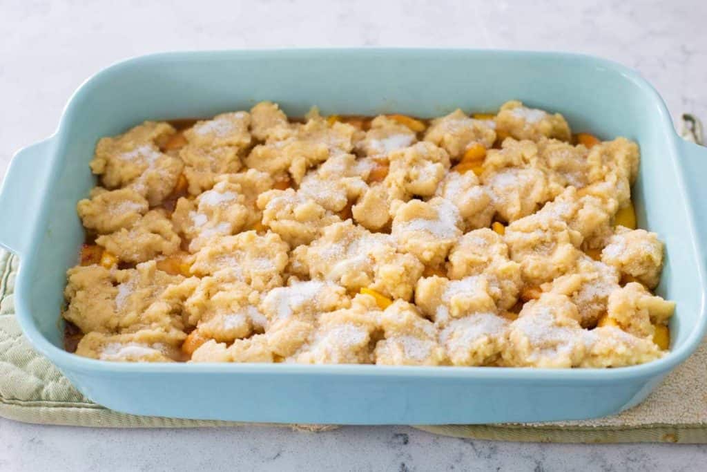 The assembled peach cobbler is ready to go in the oven.