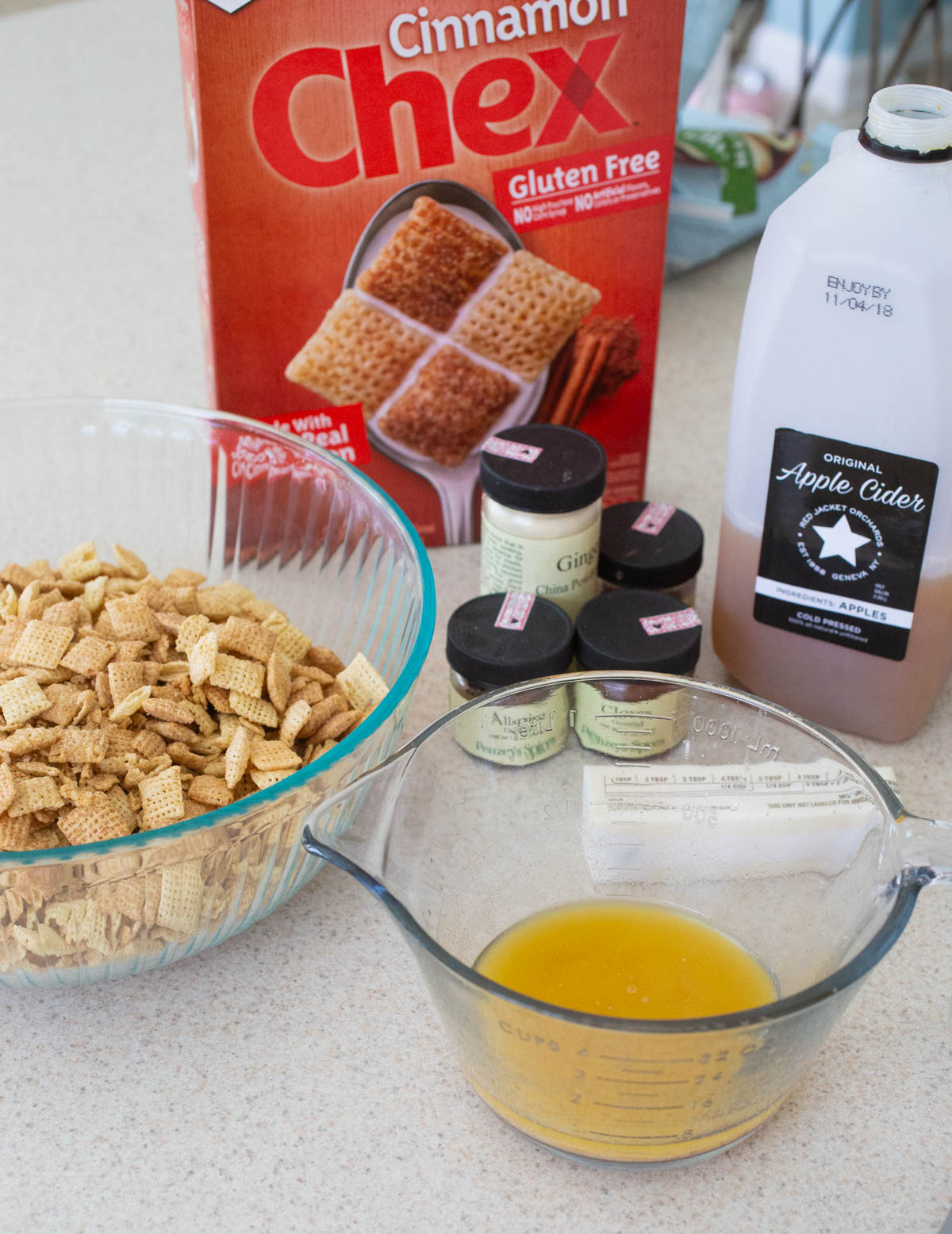The ingredients to make apple cinnamon chex mix are on the counter.