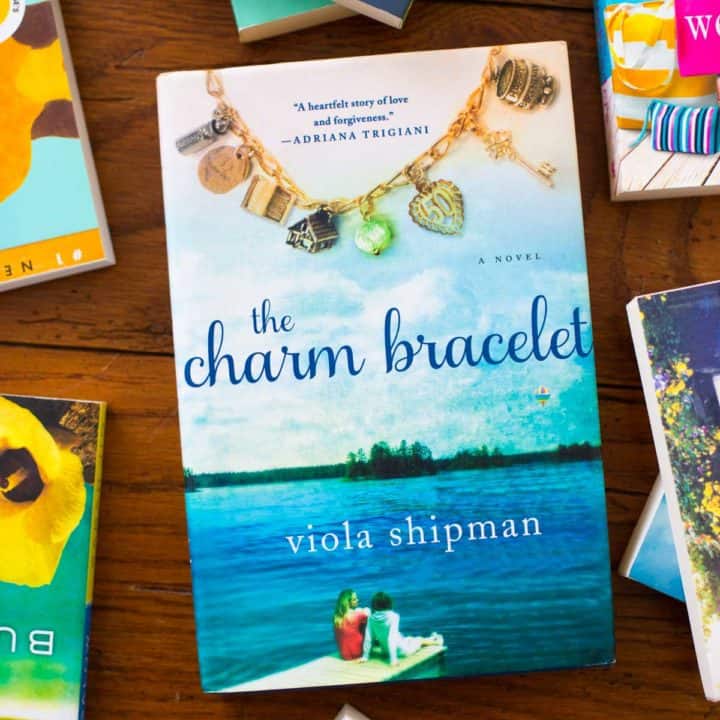 A copy of The Charm Bracelet sits on a table.