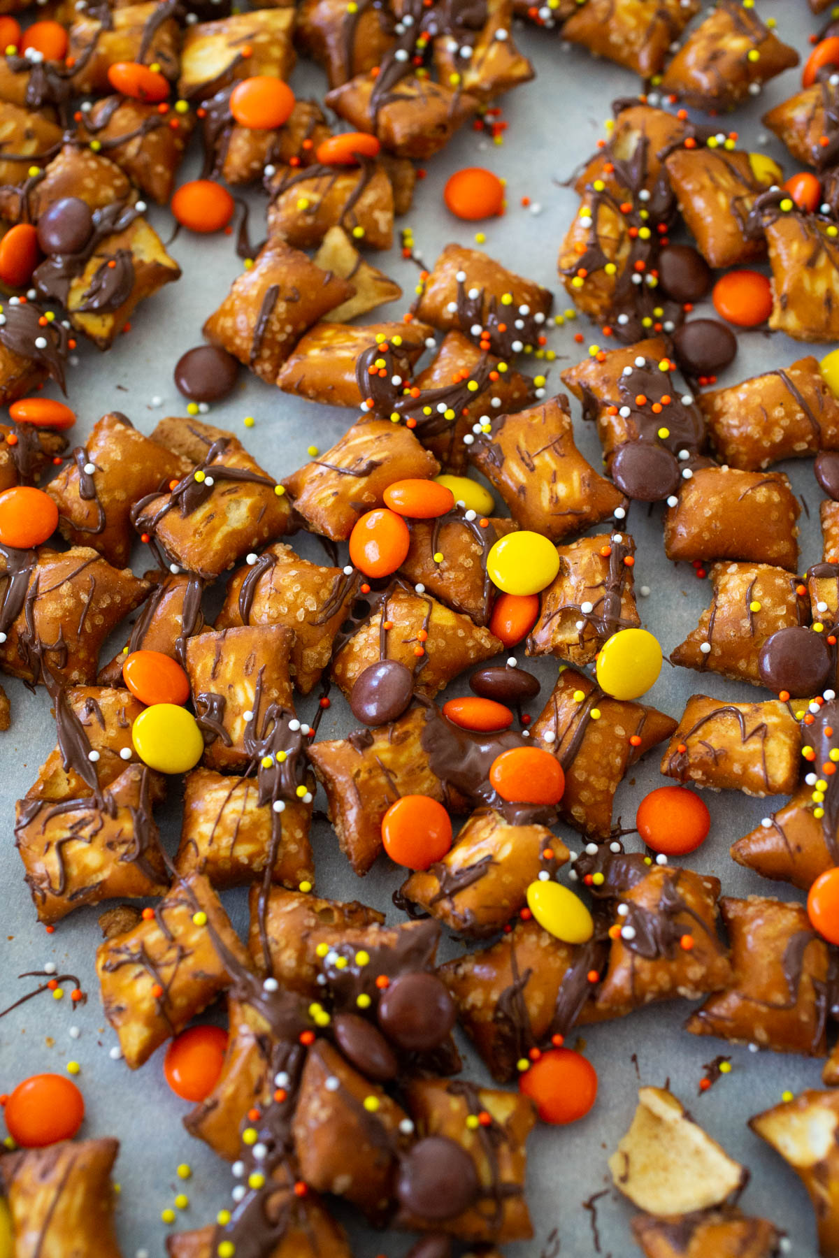 The peanut butter pretzel nuggets have been drizzled in chocolate with sprinkles and orange and yellow candies.