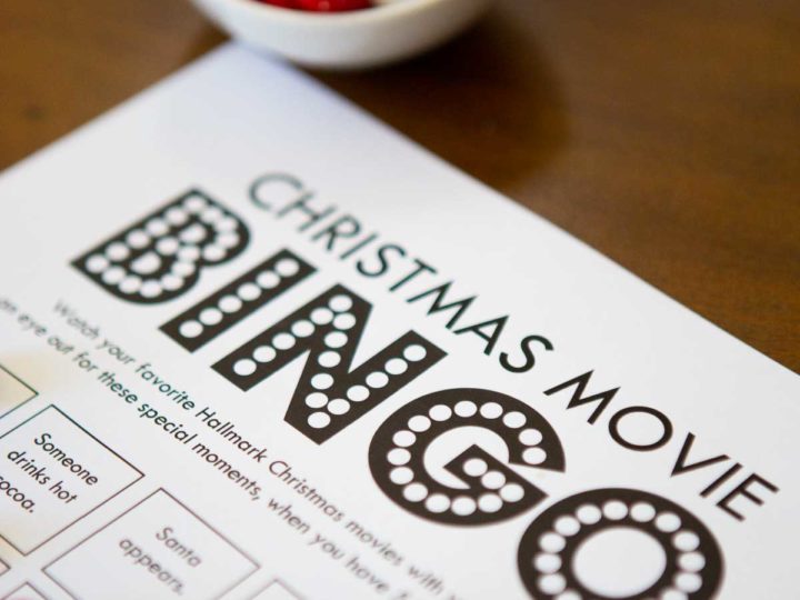 Christmas movie bingo game has red candy markers holding place.