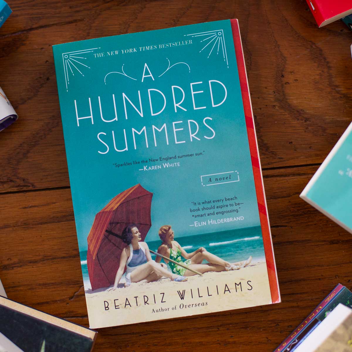 A copy of A Hundred Summers sits on a table.