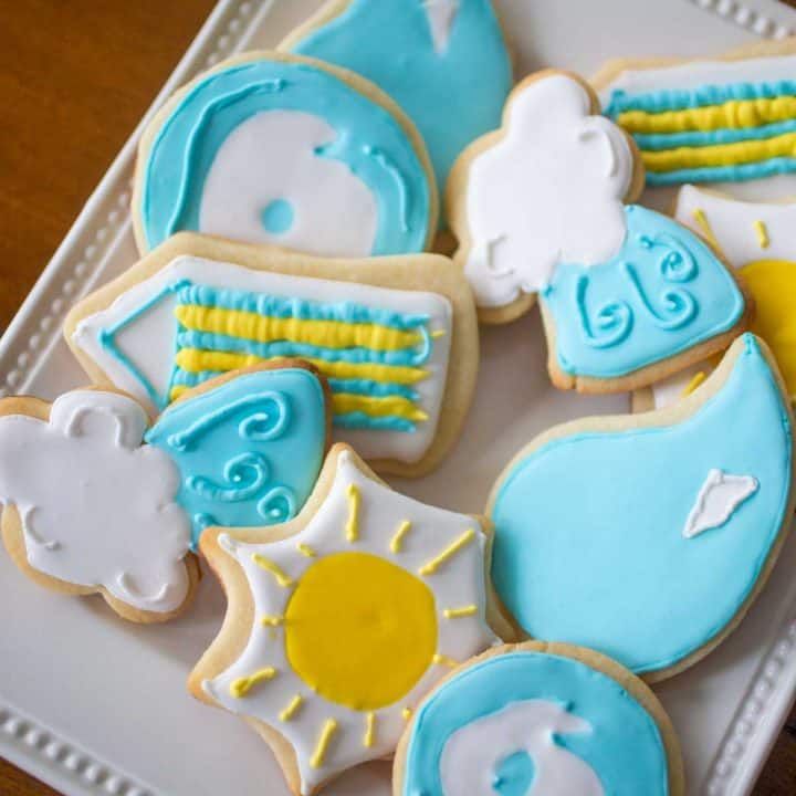 A platter of sugar cookies features weather-related shapes. Sunshine, Rain Drops, Cloud and Wind.