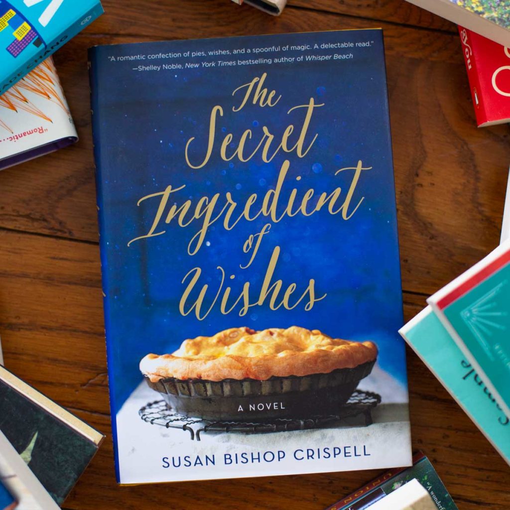 A copy of The Secret Ingredient of Wishes sits on a table.