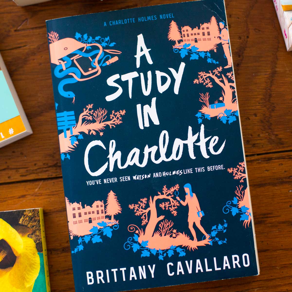 A copy of A Study in Charlotte sits on a table.