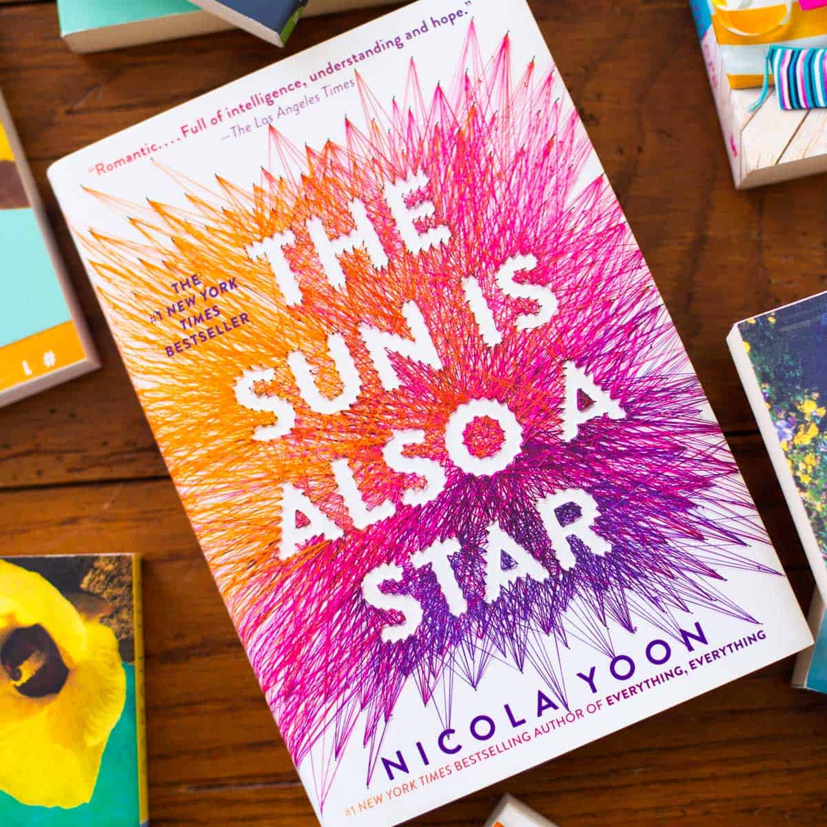 A copy of The Sun is Also a Star sits on a table.