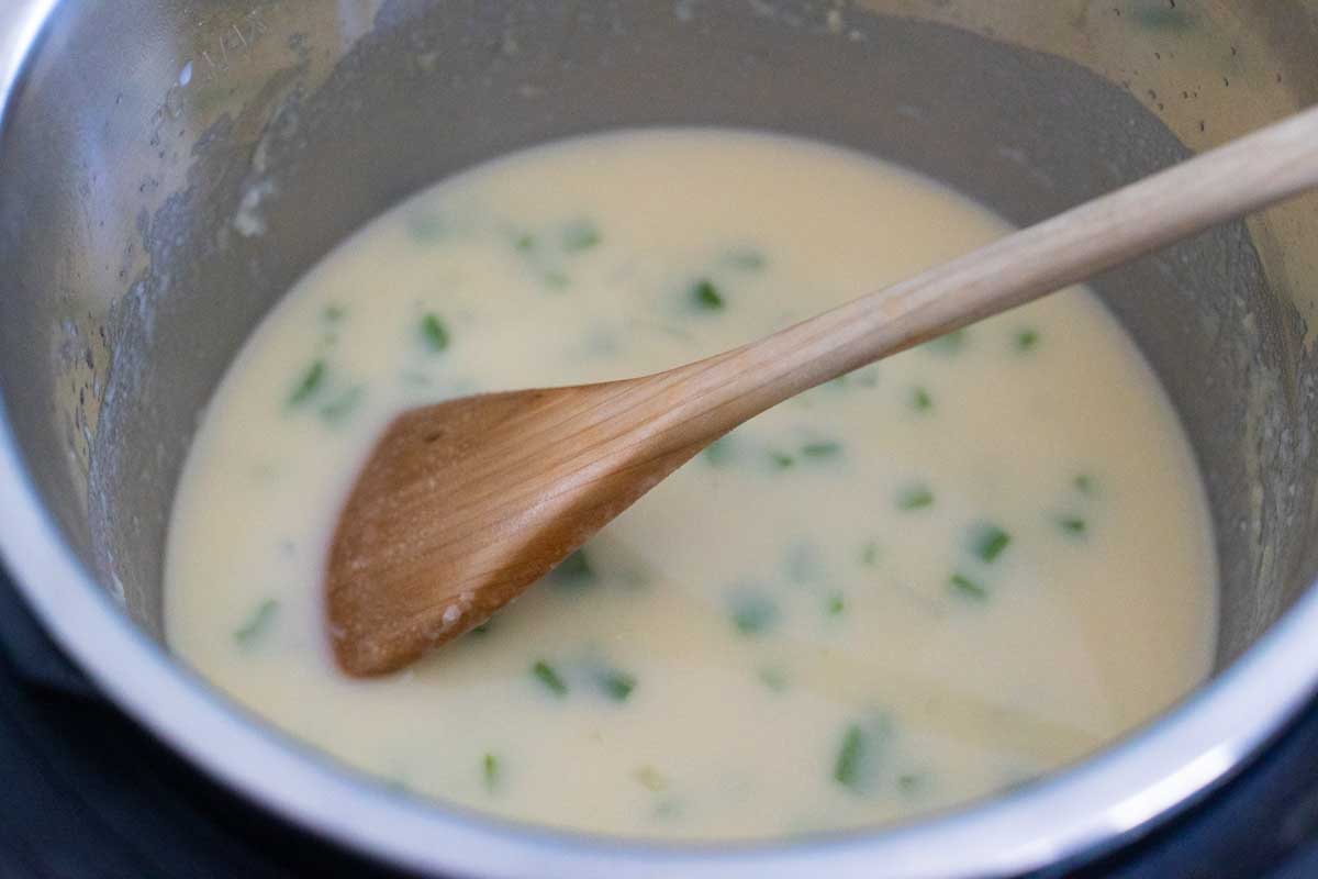 The chicken stock has been added slowly so that the flour can be whisked in smoothly.