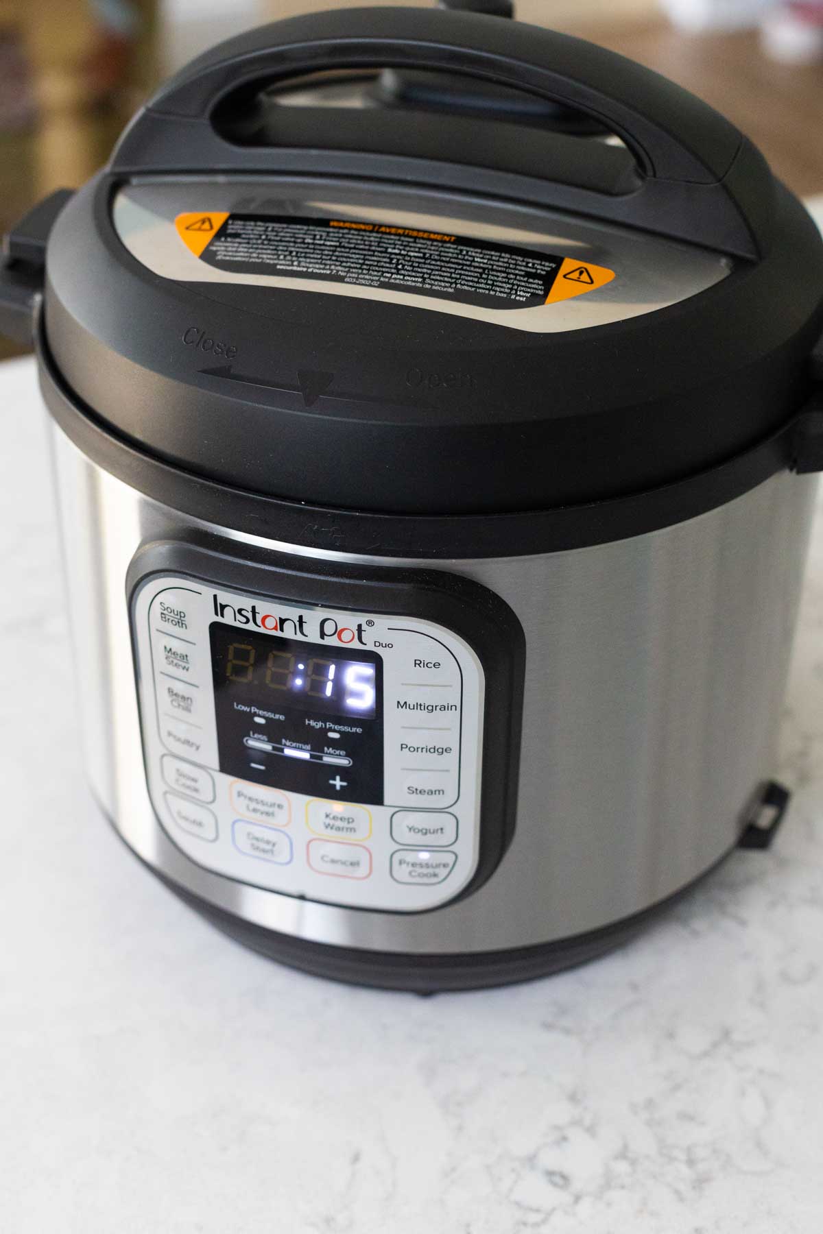 The instant pot is on the counter with the soup inside. The timer reads "15 minutes"