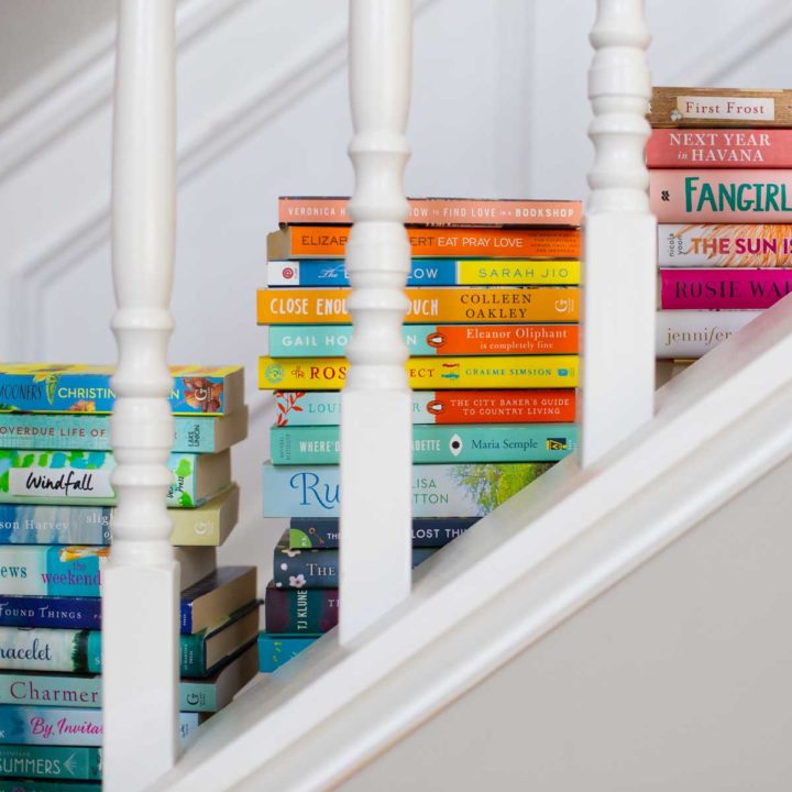 Piles of book club books sit on a set of stairs