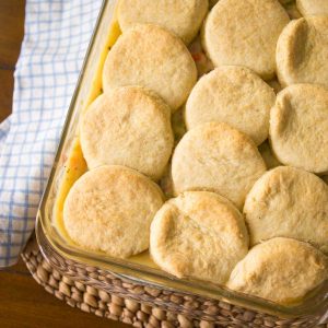 A baking pan filled with ham pot pie filling and topped with fresh homemade biscuits instead of pie crust.