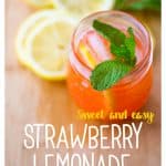 A glass of pink lemonade with fresh lemon slices.