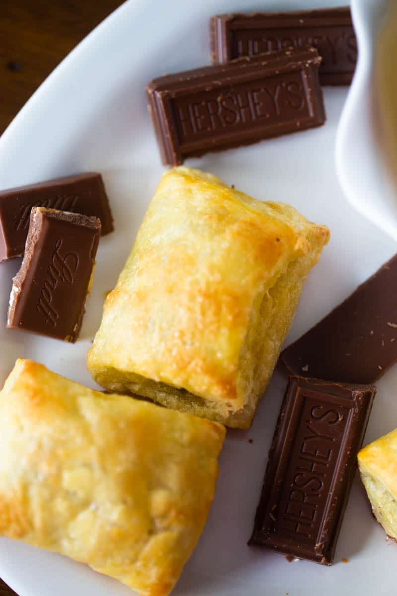 A close up of the flaky puff pastry dough once it has been baked. There are chocolate squares on the platter, too.