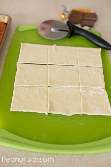 The puff pastry dough has been rolled out and trimmed into equal pieces. 