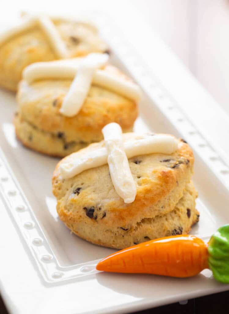 A platter of biscuits with frosting crosses on the top.
