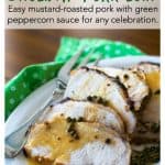 The sliced pork loin on a platter with sauce drizzled over the top.
