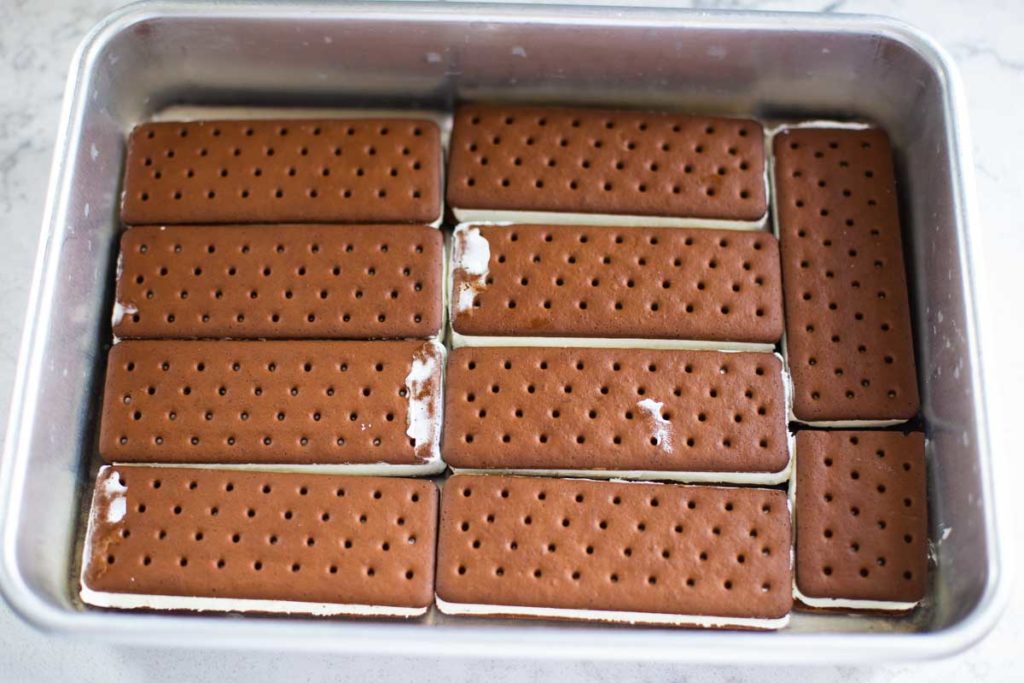 Step 1: The ice cream sandwiches are layered in an even layer on the bottom of the pan.