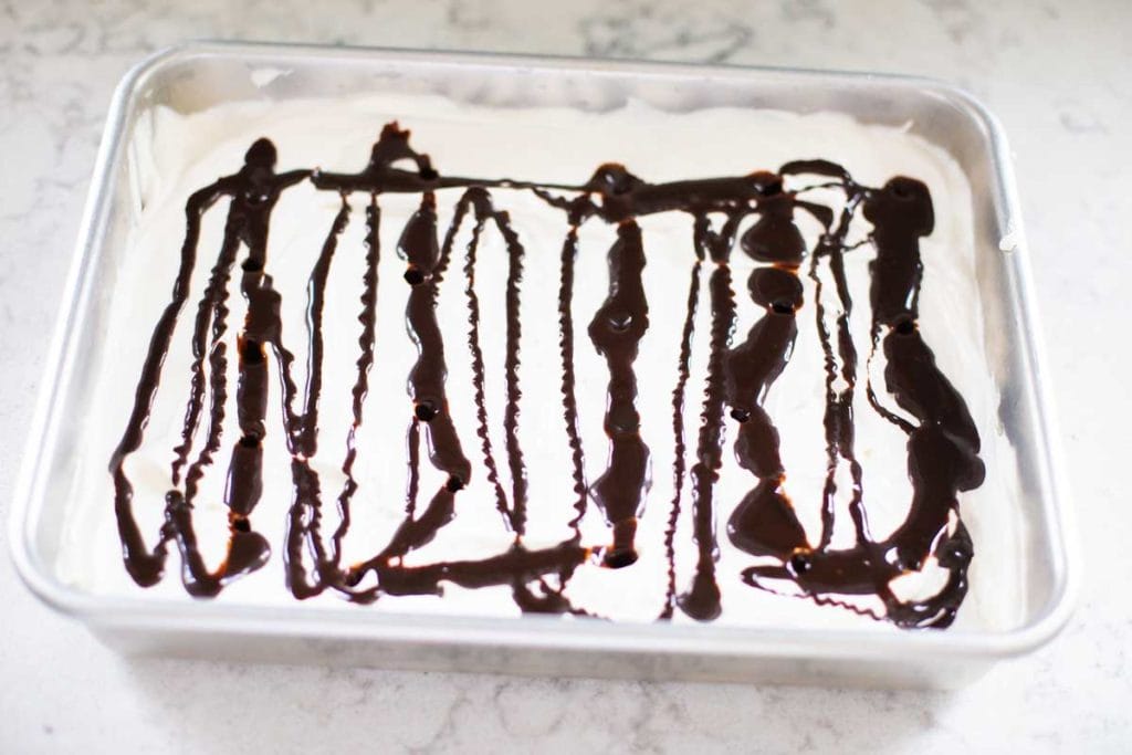 Step 2: A layer of Cool Whip has been covered with fudge.