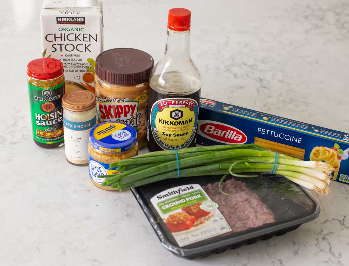The ingredients to make spicy peanut butter noodles with pork are on the counter.