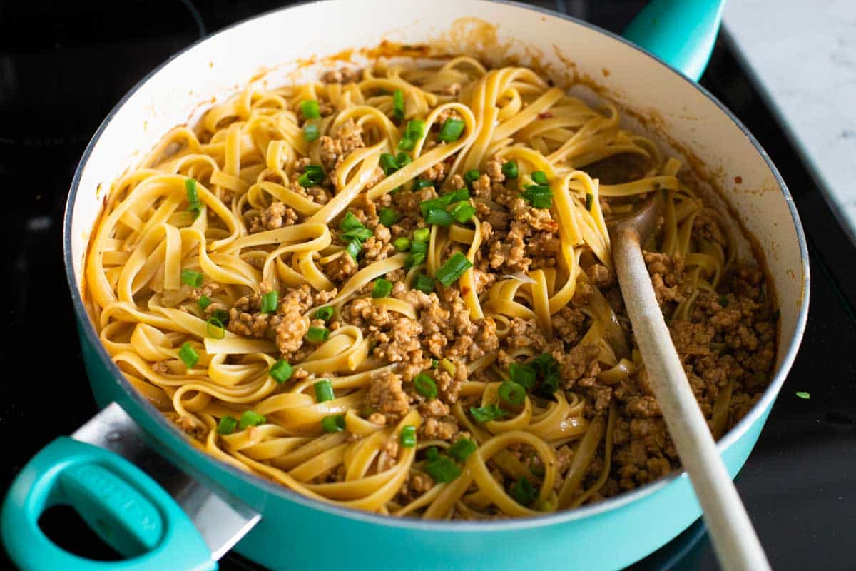 The finished pan of peanut butter noodles with green onions.