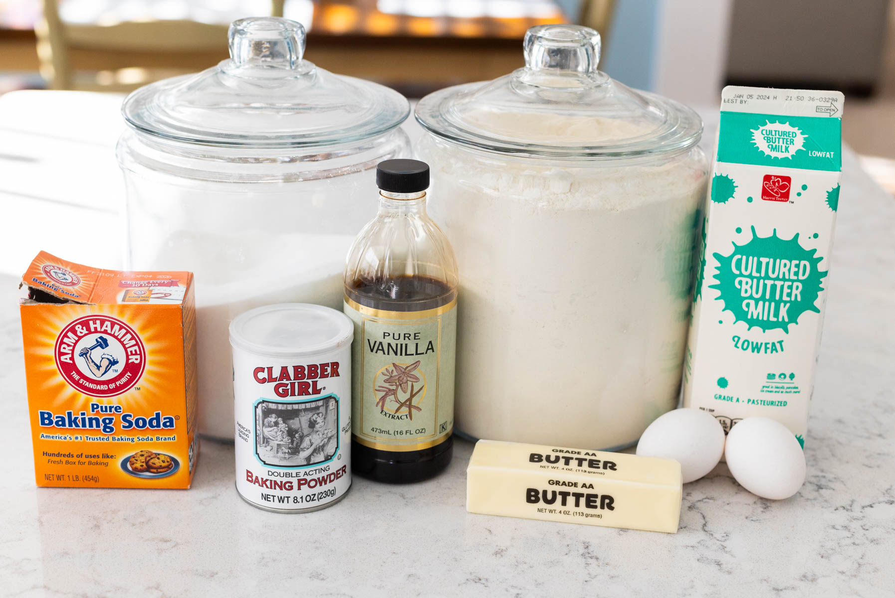 The ingredients to make buttermilk waffles are on the counter.