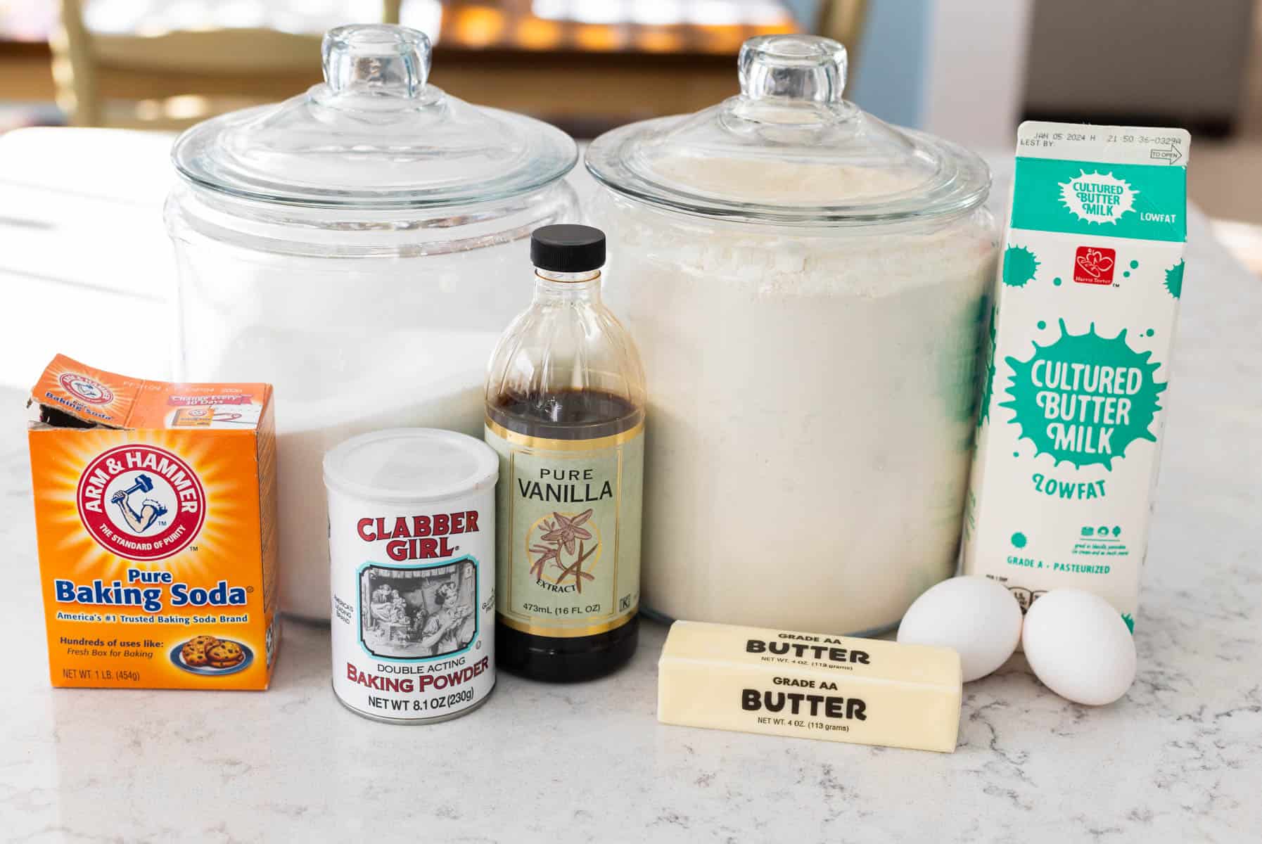 The ingredients to make buttermilk waffles are on the counter.