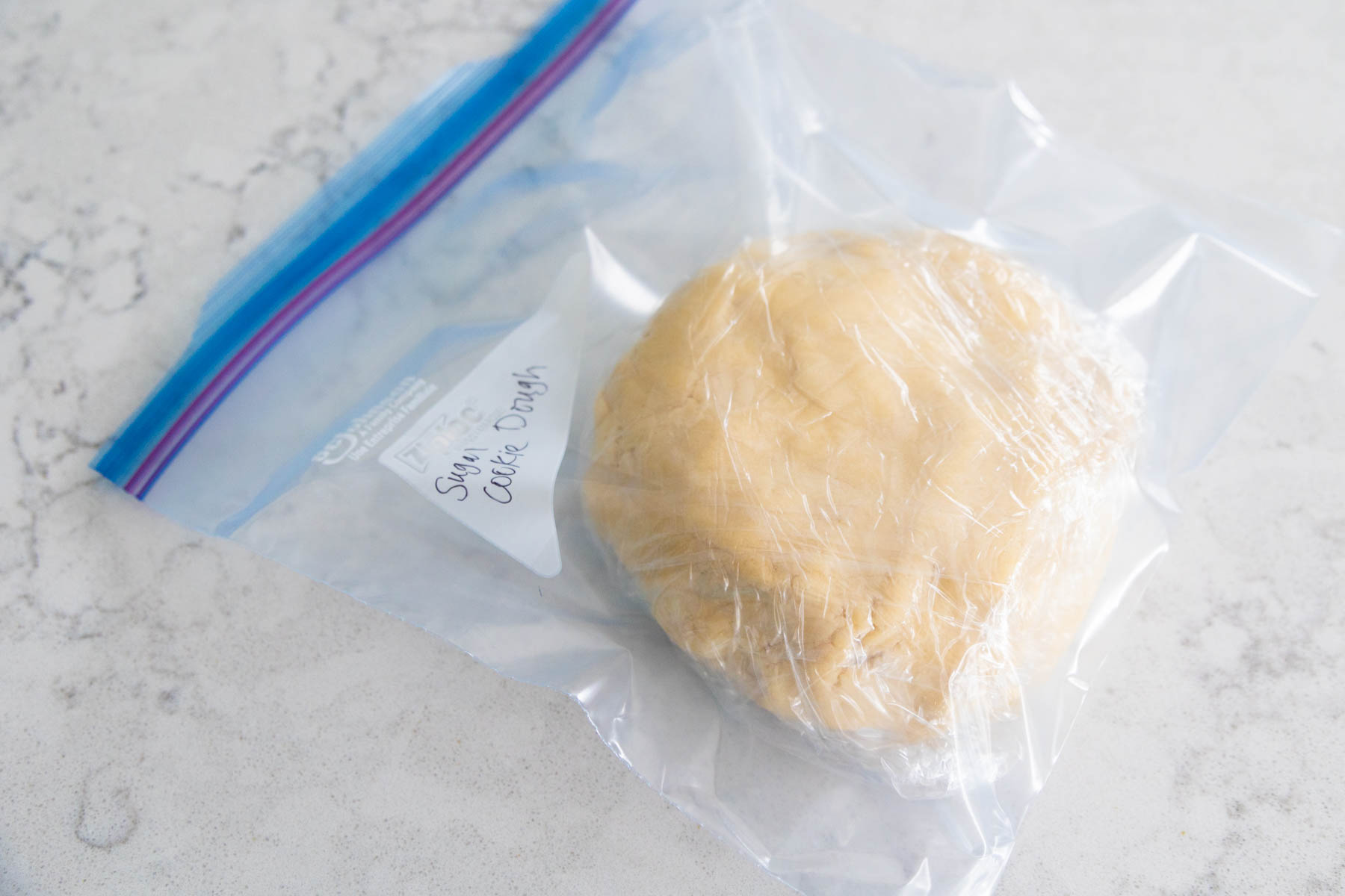The sugar cookie dough has been sealed in a plastic bag for the freezer.